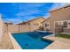 Backyard pool with cool, clear water, exterior house elevation, rock landscaping and blue sky overhead at 3532 E Alfalfa Dr, Gilbert, AZ 85298