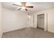 A bedroom with ceiling fan, closet access, and bathroom is well lit at 3635 W Cortez St, Phoenix, AZ 85029