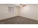 Carpeted bedroom with ceiling fan and window for great natural light at 3635 W Cortez St, Phoenix, AZ 85029