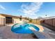 Backyard pool with diving board surrounded by patio and black metal fence at 3635 W Cortez St, Phoenix, AZ 85029