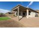 Backyard featuring a covered patio, gravel landscaping, and a small patch of artificial turf at 37808 N Pagoda Ln, Phoenix, AZ 85086