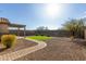 Backyard featuring gravel landscaping, a small patch of artificial turf, and a brick paver path at 37808 N Pagoda Ln, Phoenix, AZ 85086