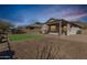 Backyard featuring a covered patio, gravel landscaping, and a small patch of artificial turf at 37808 N Pagoda Ln, Phoenix, AZ 85086