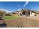 Backyard featuring a covered patio, gravel landscaping, and a small patch of artificial turf at 37808 N Pagoda Ln, Phoenix, AZ 85086