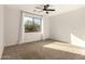 A spacious bedroom featuring neutral carpeting, and a large window at 37808 N Pagoda Ln, Phoenix, AZ 85086