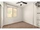 An ample bedroom with a ceiling fan and a large window at 37808 N Pagoda Ln, Phoenix, AZ 85086