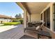 Spacious covered patio with outdoor furniture and view of the putting green at 3781 S Pablo Pass Dr, Gilbert, AZ 85297