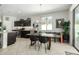 Eat-in dining area with a modern chandelier and a view of the kitchen and backyard through large windows at 3781 S Pablo Pass Dr, Gilbert, AZ 85297