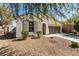 Low angle exterior view of single story home with desert landscaping, brown shutters, and a tiled roof at 3781 S Pablo Pass Dr, Gilbert, AZ 85297