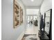 Hallway with tile floors and decorative art leading to an open concept kitchen and living space at 3781 S Pablo Pass Dr, Gilbert, AZ 85297