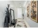 Inviting hallway featuring tile flooring, art, a bench with storage, mirror and a coat rack at 3781 S Pablo Pass Dr, Gilbert, AZ 85297