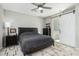 Main bedroom with a sliding barn door to the bathroom, carpet, and ceiling fan at 3781 S Pablo Pass Dr, Gilbert, AZ 85297