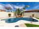 Beautiful in-ground pool with rock waterfall feature surrounded by desert landscaping at 3781 S Pablo Pass Dr, Gilbert, AZ 85297