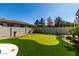 Backyard putting green with desert landscaping and mature trees at 3781 S Pablo Pass Dr, Gilbert, AZ 85297