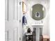 Well-lit powder room featuring a pedestal sink, round mirror, and decorative artwork, creating a stylish space at 3793 E Canyon Pl, Chandler, AZ 85249