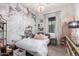 Charming bedroom featuring a beautiful floral accent wall and a stylish crystal chandelier at 3793 E Canyon Pl, Chandler, AZ 85249