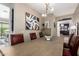 Open dining room featuring a long wood table, red leather chairs, and decorative accents throughout at 3793 E Canyon Pl, Chandler, AZ 85249