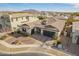 Beautiful single story home with three-car dark garage doors, stone accents, and mature landscaping at 3793 E Canyon Pl, Chandler, AZ 85249