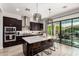 Bright kitchen with a large island, stainless steel appliances and dark wood cabinets at 3793 E Canyon Pl, Chandler, AZ 85249