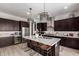 Kitchen features stainless steel appliances, dark wood cabinets, and a large island at 3793 E Canyon Pl, Chandler, AZ 85249