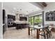 Spacious kitchen with dark wood cabinets, stainless steel appliances, large island, and adjacent dining area at 3793 E Canyon Pl, Chandler, AZ 85249