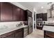 Kitchen features stainless steel appliances, dark wood cabinets, and a wine refrigerator at 3793 E Canyon Pl, Chandler, AZ 85249