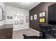 Bright home office with a view to the home's interior, and a black accent wall and chandelier at 3793 E Canyon Pl, Chandler, AZ 85249