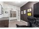 Bright home office with a black accent wall, a view to the home's interior, and a chandelier at 3793 E Canyon Pl, Chandler, AZ 85249