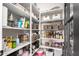 Well-organized walk-in pantry features white shelving and various baskets and food items for ample storage at 3793 E Canyon Pl, Chandler, AZ 85249