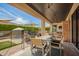 Covered patio with a dining set, ceiling fan, and view of the pool and backyard at 3793 E Canyon Pl, Chandler, AZ 85249