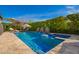 Sparkling pool with tanning deck, stone waterfalls, umbrellas, lush landscaping and lounge seating at 3793 E Canyon Pl, Chandler, AZ 85249