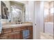 Bathroom featuring walk in style tub, a large mirror and brown vanity at 39610 N 12Th St, Phoenix, AZ 85086