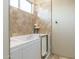 Bathroom featuring walk in style tub with textured walls at 39610 N 12Th St, Phoenix, AZ 85086