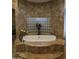 A luxurious bathroom features a tiled tub and glass block window for natural light at 39610 N 12Th St, Phoenix, AZ 85086