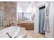 Luxurious soaking tub with tile surround and glass block window, and and vanity at 39610 N 12Th St, Phoenix, AZ 85086