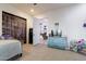 Comfortable bedroom with a blue dresser, TV, and door leading to the living room, perfect for relaxation at 39610 N 12Th St, Phoenix, AZ 85086