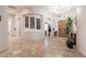 Spacious foyer featuring travertine tile flooring, arched doorways, and custom design elements at 39610 N 12Th St, Phoenix, AZ 85086