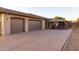 Spacious garage with large driveway and a shaded pergola on the side of this Southwestern home at 39610 N 12Th St, Phoenix, AZ 85086