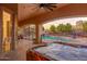 Hot tub on a covered patio overlooking a sparkling pool, desert landscaping, and decorative wrought iron fencing at 39610 N 12Th St, Phoenix, AZ 85086