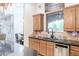 Kitchen with wood cabinets, stainless steel appliances, black countertops, tile backsplash, and an eat-in area at 39610 N 12Th St, Phoenix, AZ 85086