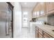 Well-organized laundry room with granite countertop, tile floors, and stainless steel refrigerator, providing convenience at 39610 N 12Th St, Phoenix, AZ 85086