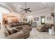 Bright open-concept living area with travertine floors, neutral decor, and a modern ceiling fan at 39610 N 12Th St, Phoenix, AZ 85086