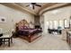 Spacious main bedroom suite featuring a stone fireplace, sitting area, and tray ceilings at 39610 N 12Th St, Phoenix, AZ 85086