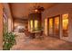 Covered patio with jacuzzi, table, chairs, ceiling fan, and view into the living room at 39610 N 12Th St, Phoenix, AZ 85086