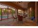 Covered patio with iron gate overlooking the pool, with table, chairs and ceiling fan at 39610 N 12Th St, Phoenix, AZ 85086