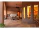 Covered patio featuring a hot tub, decorative plants, and access to the interior via multiple windows and a doorway at 39610 N 12Th St, Phoenix, AZ 85086