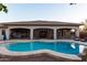 Large backyard pool with adjacent covered patio, wrought iron accents, and desert landscaping, perfect for entertaining at 39610 N 12Th St, Phoenix, AZ 85086