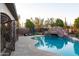 Inviting backyard pool with a rock waterfall feature and wrought iron gate, perfect for outdoor relaxation at 39610 N 12Th St, Phoenix, AZ 85086