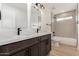 Bathroom featuring a double sink vanity, patterned tile accent wall and modern fixtures at 42 E 14Th St, Mesa, AZ 85201