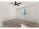 Bright bedroom with a ceiling fan, window, and wood-look flooring at 42 E 14Th St, Mesa, AZ 85201